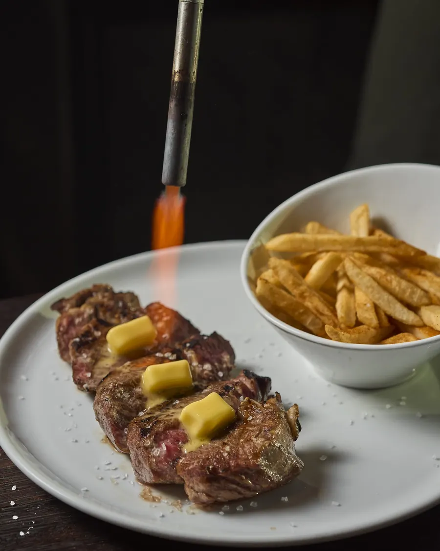 Beef steak finished with a torch, with fries